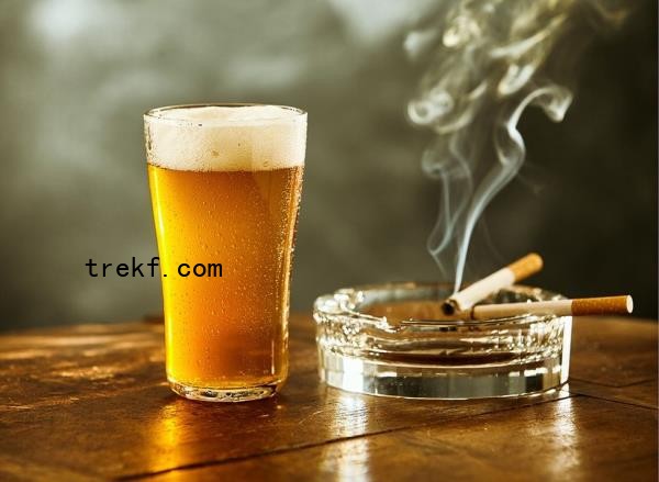 A pint of beer and a cigarette in an ashtray