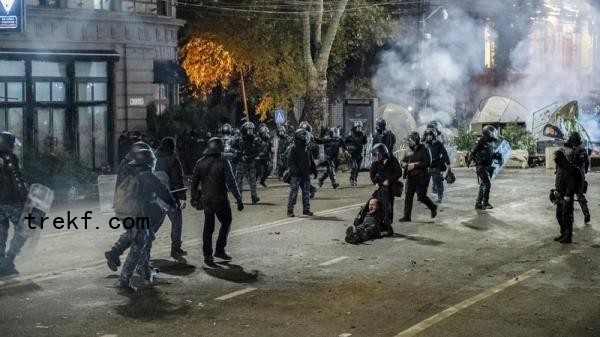 Georgian police drag a man away after surrounding protesters and making a large number of arrests during an anti-government protest