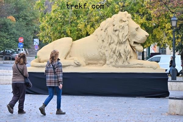 Pedestrians walk past a giant Lego lion statue by Hungarian artist Balazs Doczy, a replica of one of the lion statues of the oldest bridge of Hungary — the Chain Bridge — in Budapest, on October 28, 2022. — AFP pic